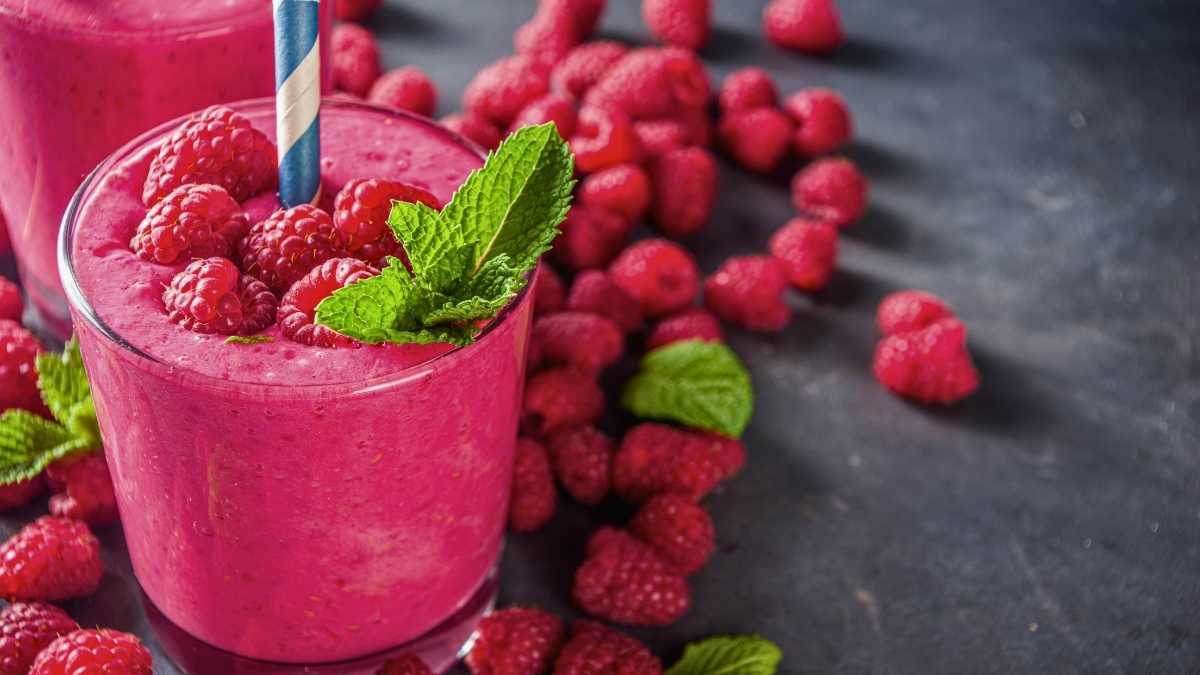 Ly sinh tố phúc bồn tử màu đỏ ruby đậm, ánh sáng tự nhiên phản chiếu